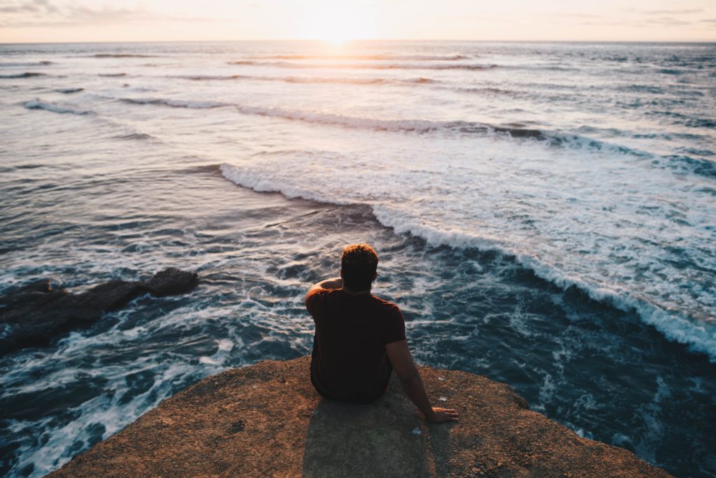 A man at the water's edge calmly contemplating the benefits of counseling and therapy