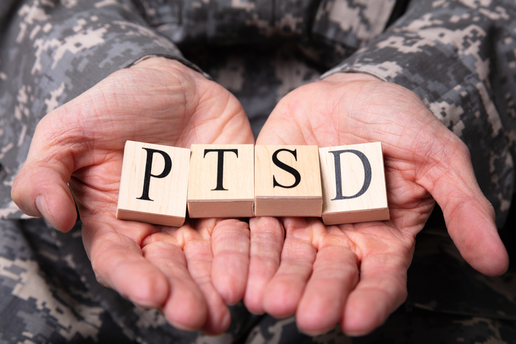 Military Soldier holding PTSD Cubes seeking Treatment for PTSD