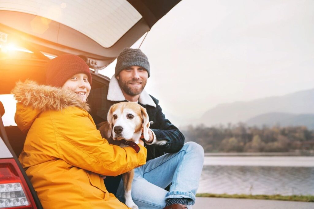 father, son and dog smiling due to christian counseling