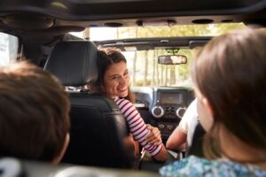 mother looking at children in the back seat and practicing an attitude of gratitude