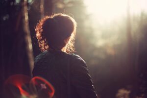 a woman in the woods contemplating loneliness vs. anxiety and how counseling can help in savannah, ga