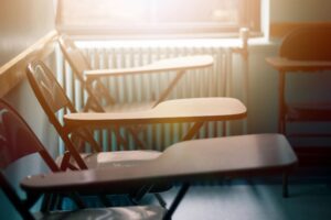 row of empty desks in a classroom after the threat of school shooting