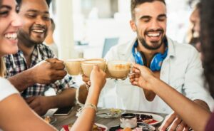 friends and family gathered around a table practicing an attitude of gratitude