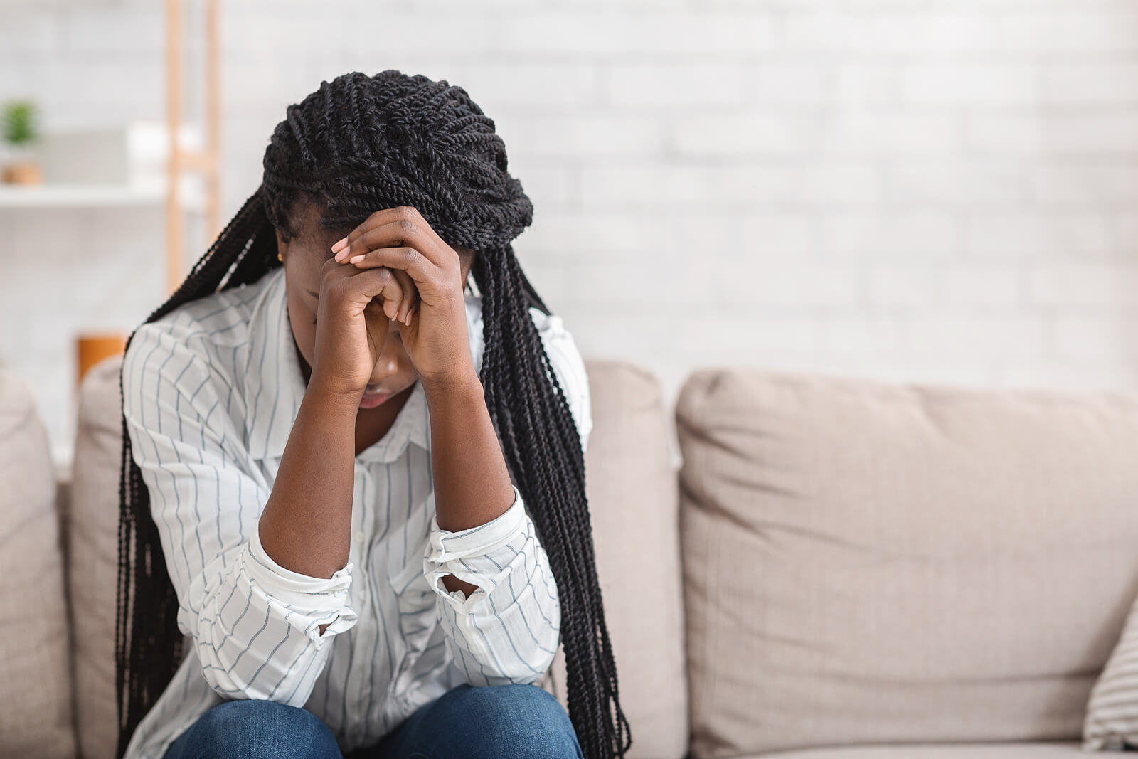 A teen covers her face as she sits on a couch. This could represent the stress an anxiety therapist in Savannah, GA can offer support with. Learn how counseling for teenagers in Savannah, GA can offer support by searching for an anxiety therapist near me today.