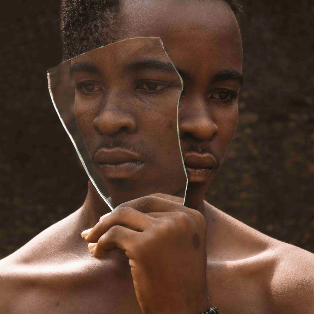 Young man holds a piece of glass that could represent march self-harm awareness in Savannah, GA