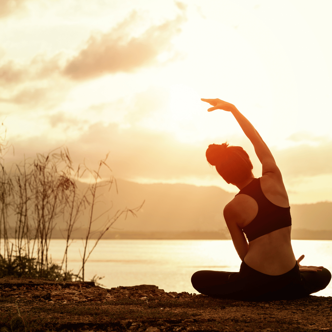 This image of a woman gazing at the sunset doing yoga could represent tools for lowering anxiety that a therapist in Savannah, GA could help you out with in the 31401 area code.